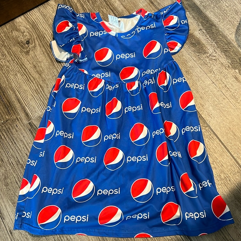 Girls Pepsi dress. Soft stretchy material. Size 5/6T-XL. Ruffled like sleeves